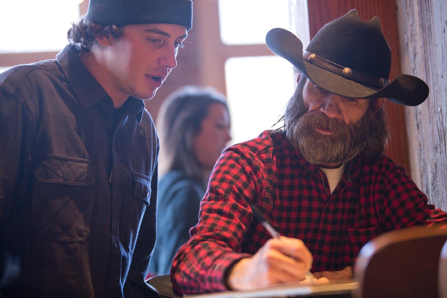 RBC Olympian and RBC Avion Visa Cardholder Mark McMorris speaking to a local man from Aspen who creating a sketch