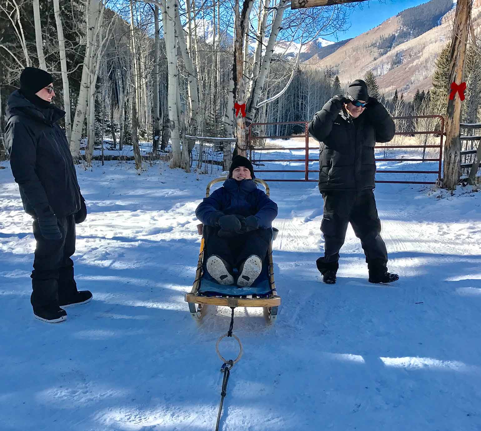 Mark McMorris on a dogsled with two onlookers