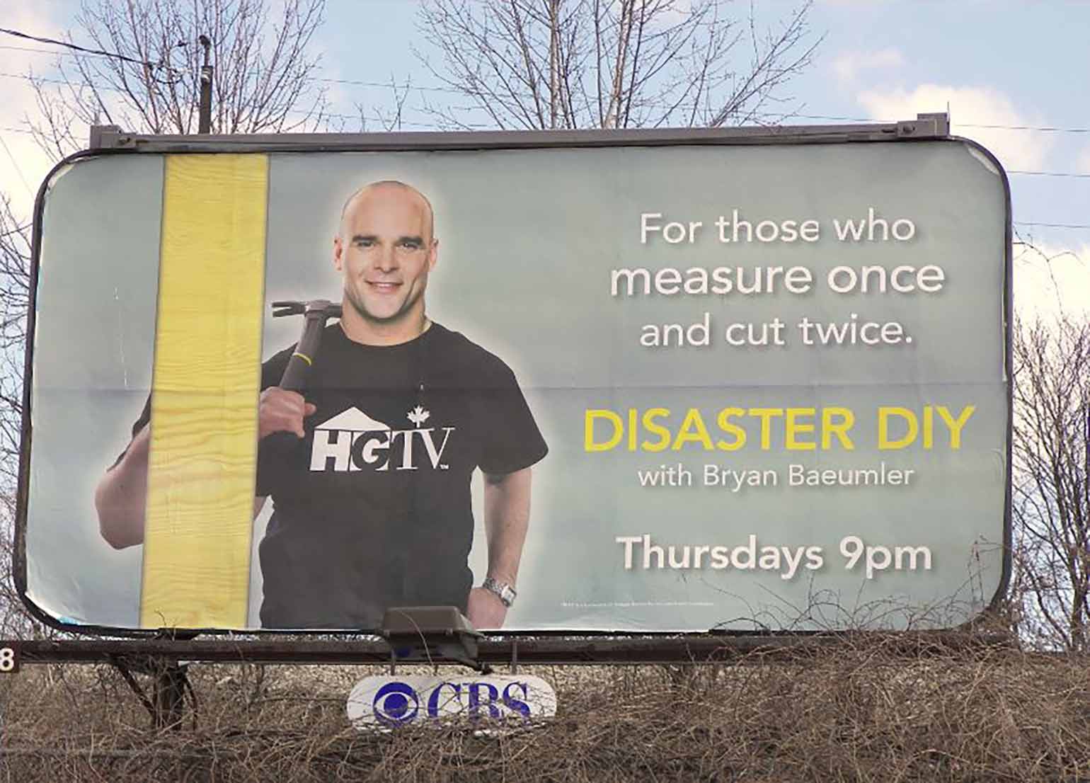 Image of a billboard with Bryan Baeumler holding a hammer. Billbaord reads: DIY Disasters. For Those Who Measure Once and Cut Twice.