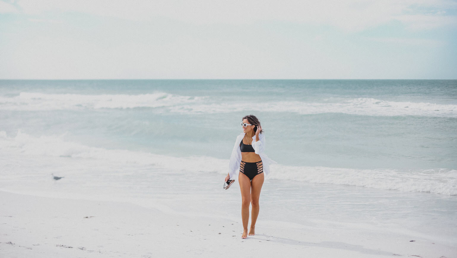 A brunette blogger in front of the beach in Florida 