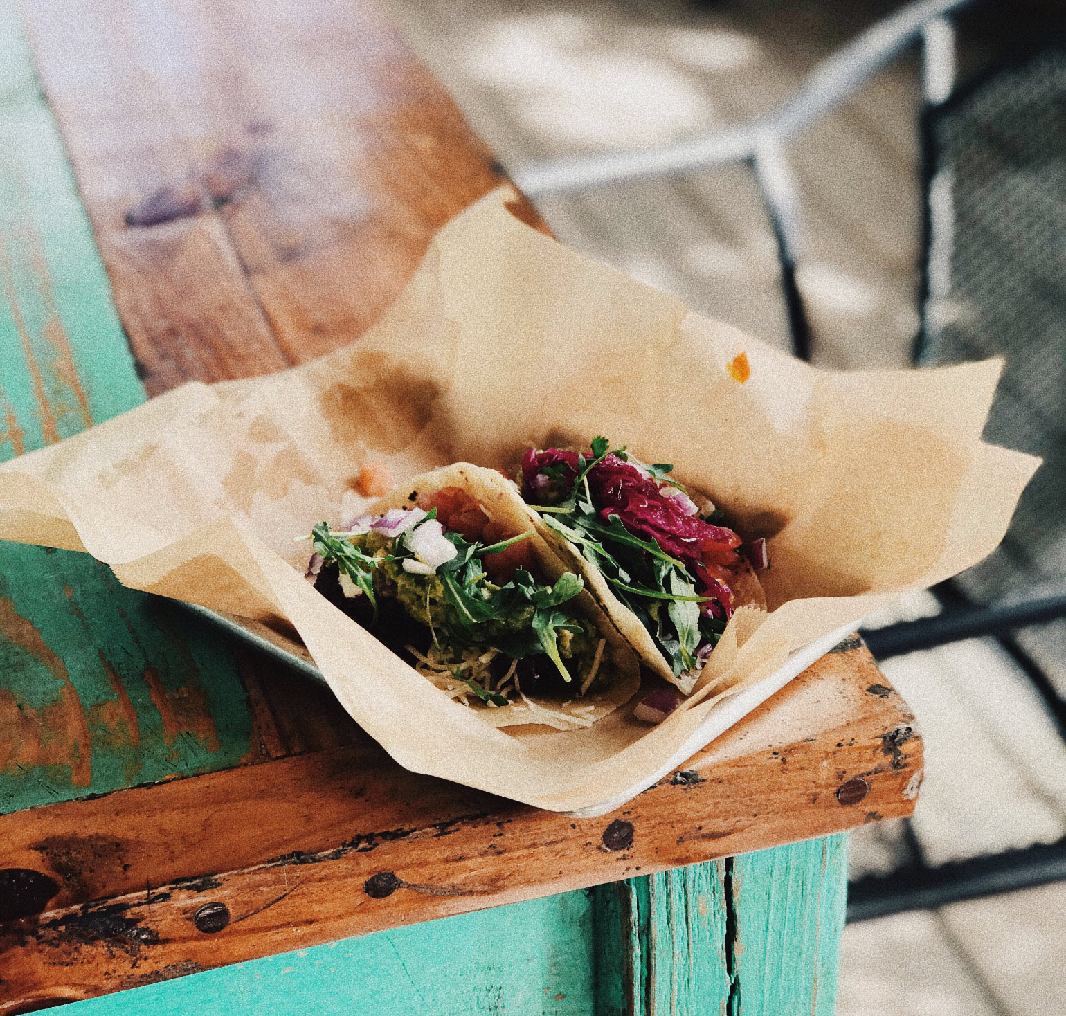 Two tacos on a picnic table 