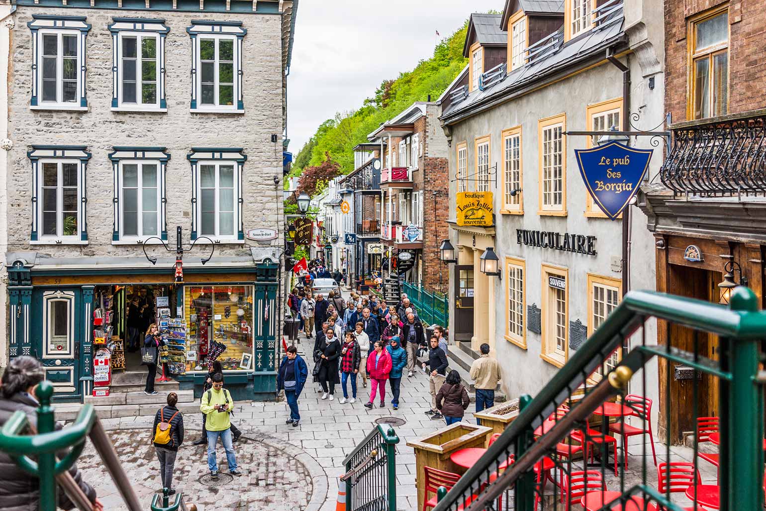 People exploring the stores and restaurants on Rue du Petit Champlain in Quebec City.