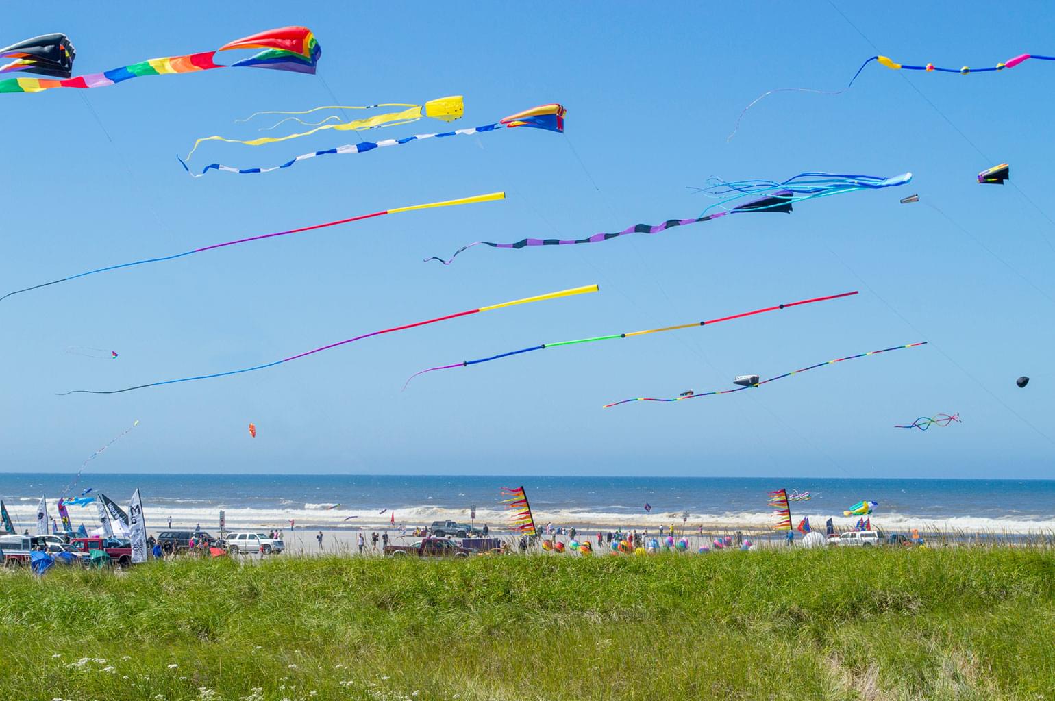 Multicolored Kites flying on the beach as part of the Lincoln City Summer Kite Festival.