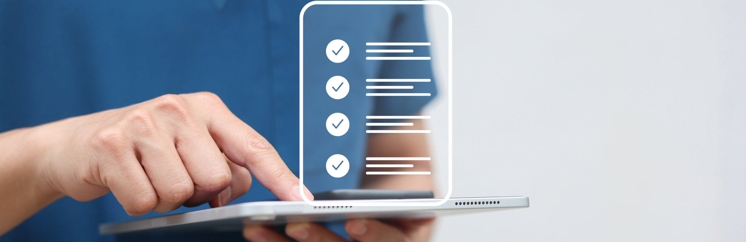Hand holding tablet displaying digital checklist with checkmarks