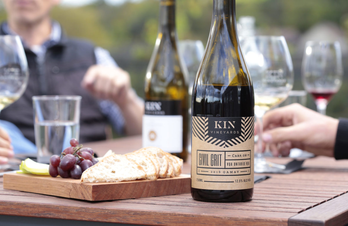 A charcuterie platter beside an unopened bottle of wine at Kin Vineyards in Ottawa