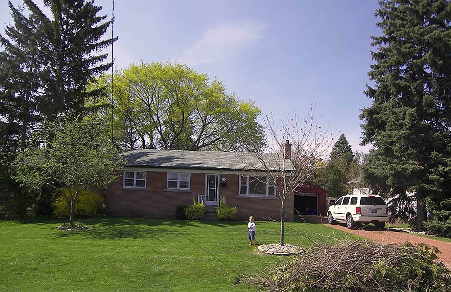 Image of Bryan & Sara's first home. A humble, red Brick bungalow.