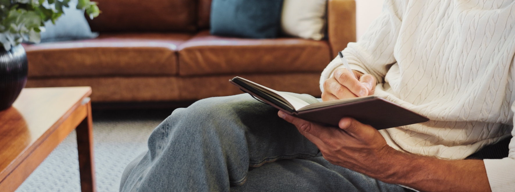 A man journaling on a notebook.