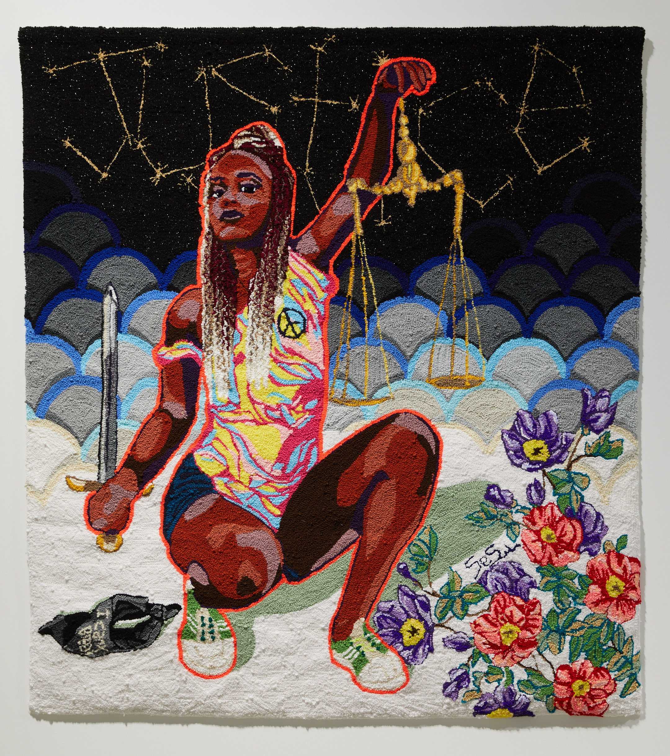 Tapestry of a black woman crouching and holding the scales of justice and a sword with flower sin the background. The word 