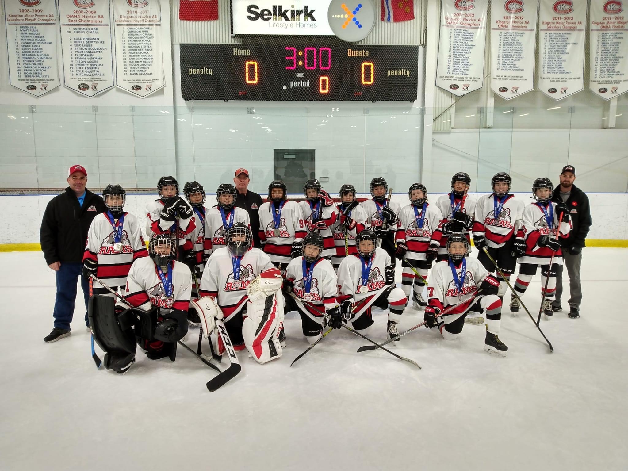 The Stittsville Rams U12 in their game gear on the ice with their coaches