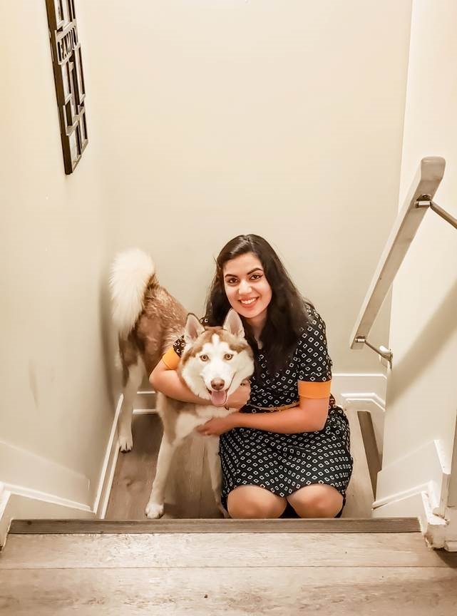 Jaipreet Kaur hugging her husky dog.