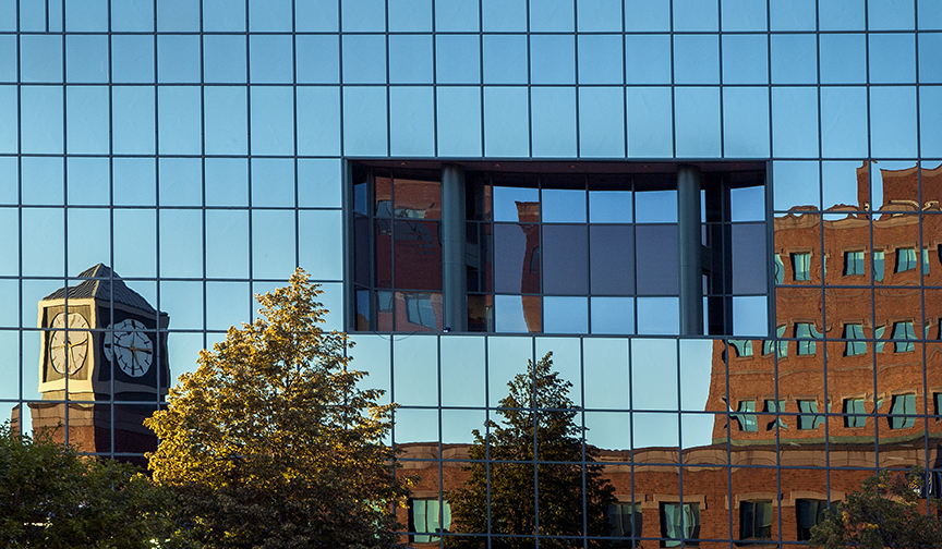 A reflective exterior of an office building in downtown Moncton.