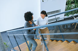 Two females taking stairs.