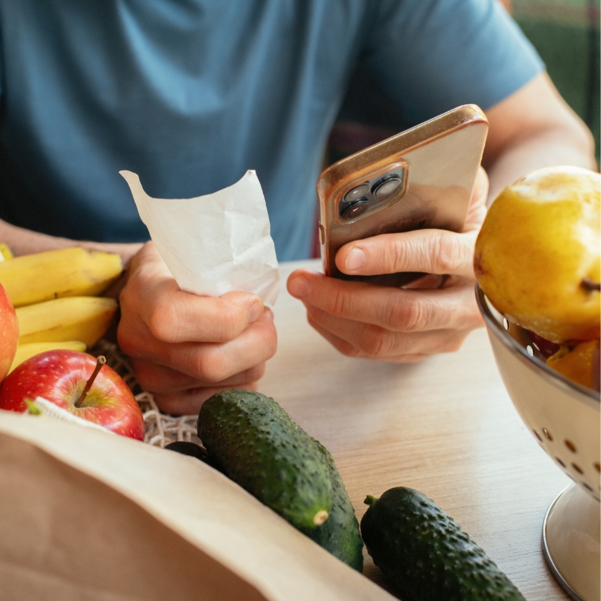 A male tallying bill over phone.