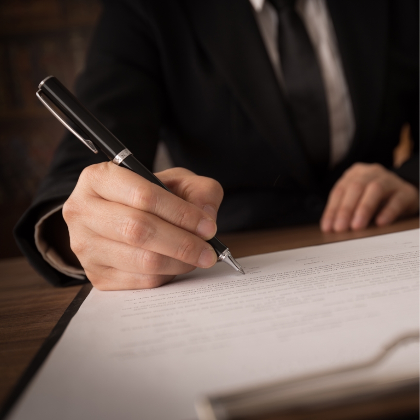 A women writing on a piece of paper.