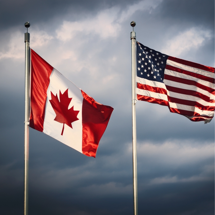 Canadian flag along with United States of America flag standing side by side.