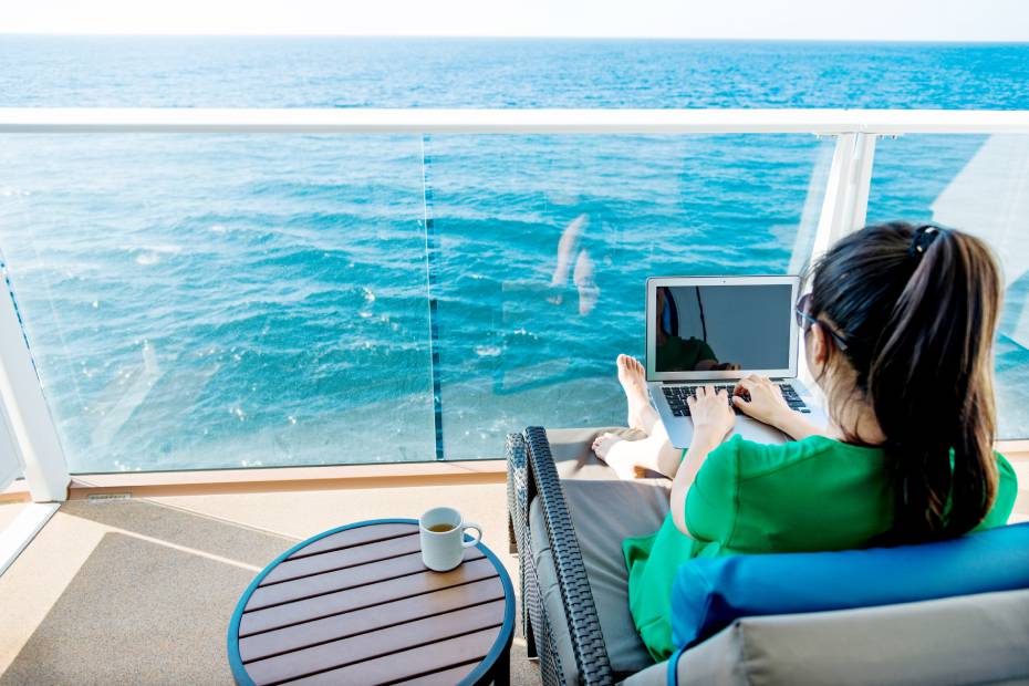 Woman on cruise ship using laptop.
