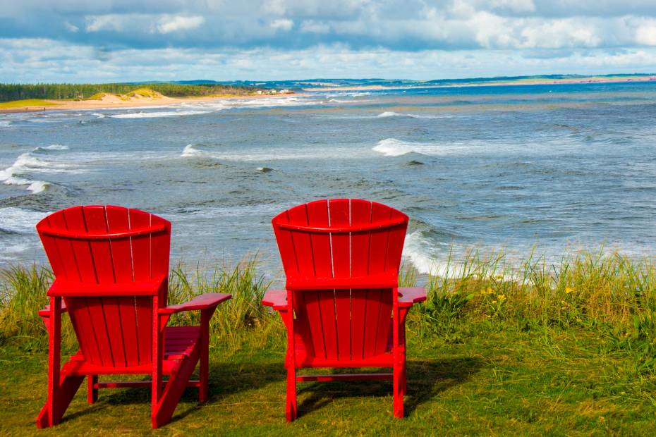 2 red Adirondack chairs overlooking the beach in PEI