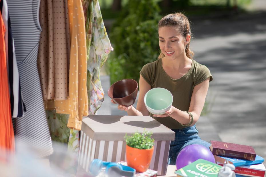 Long haired woman holding empty pots and deciding which one is better.