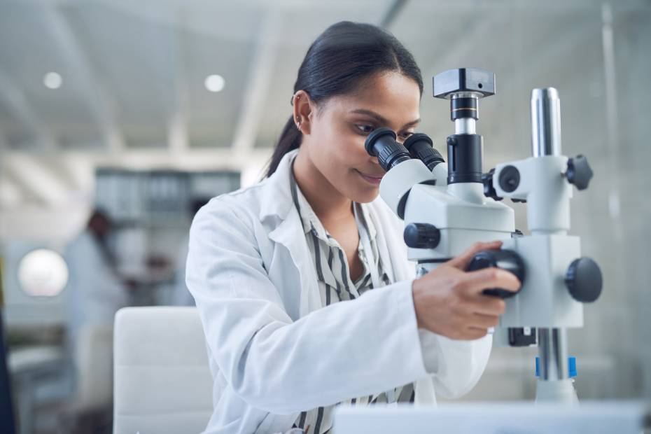 An image of a female pathologist working at the lab