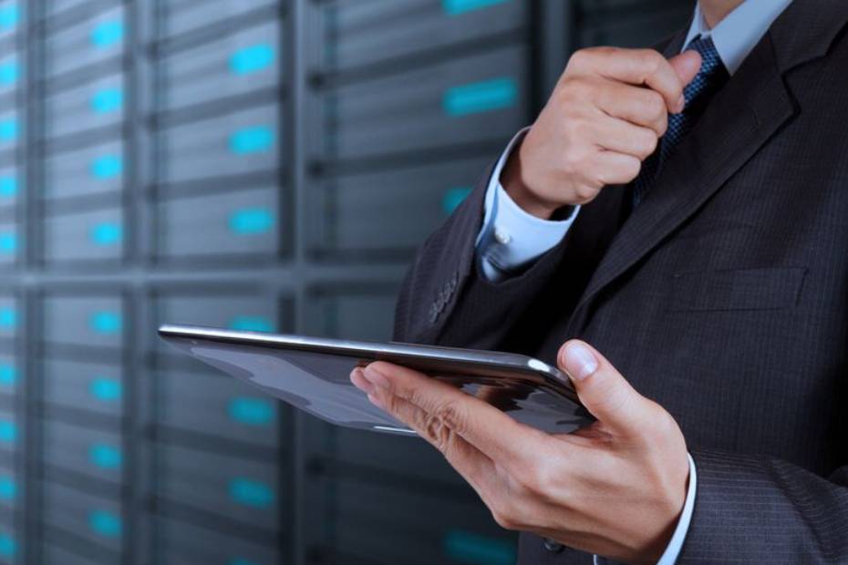 Man in suit holding tablet