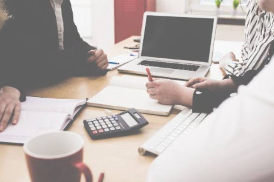 People working on a table with laptop