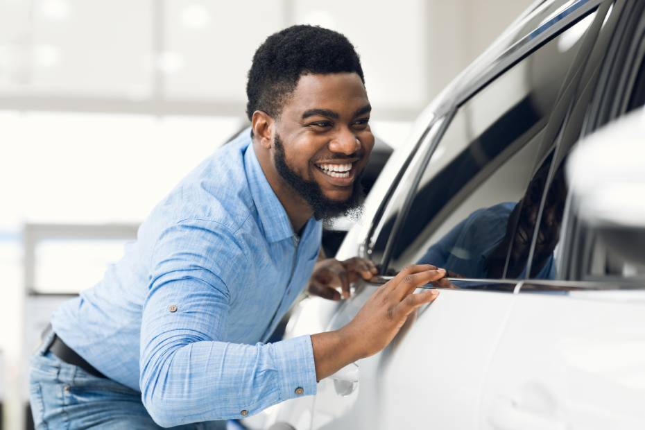 Man looking at new car to buy