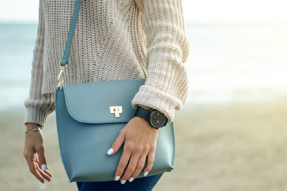 Woman with hand on purse.