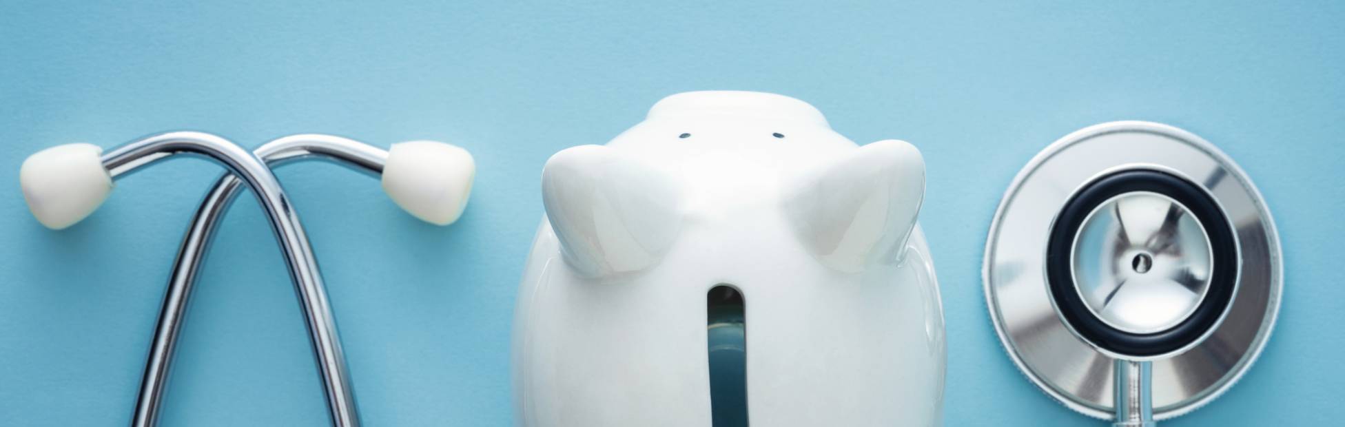 A picture showing a piggy bank and a pair of stethoscope.
