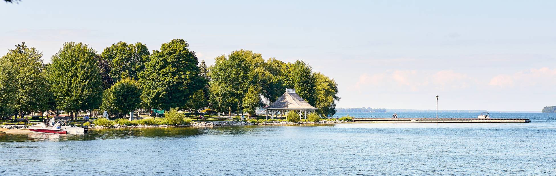 A lake with a dock and park