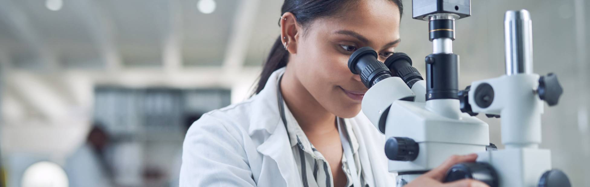 An image of a female pathologist working at the lab