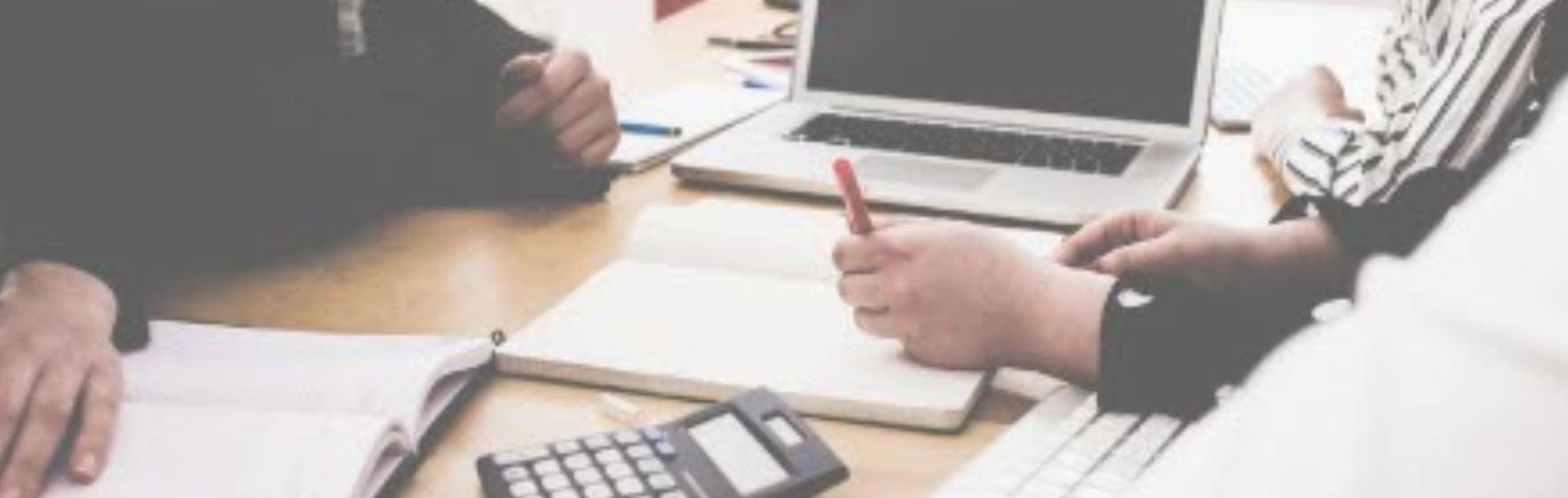 People working on a table with laptop