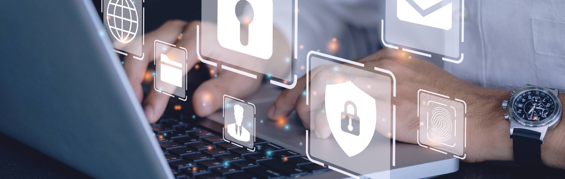 An employee typing on a laptop, with illustrations of locks representing cyber security