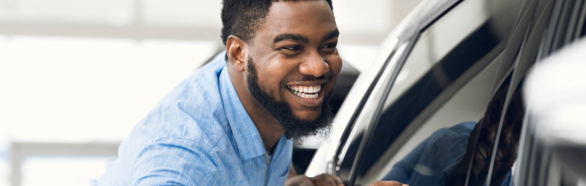 Man looking at new car to buy