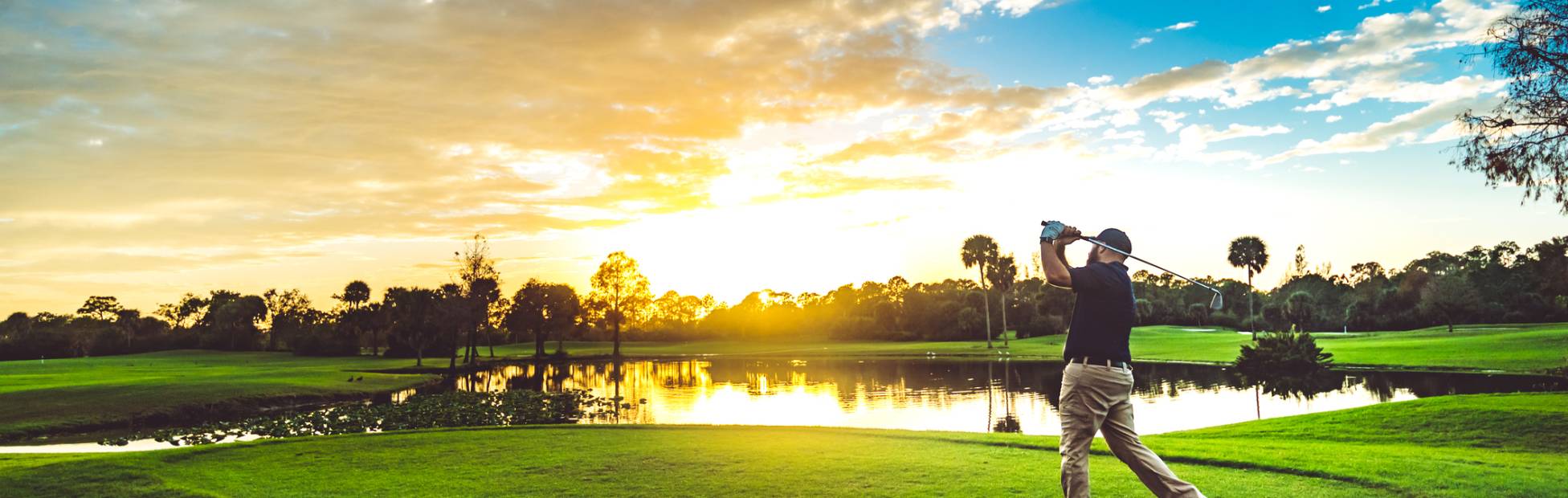 Man playing golf on a gold course.