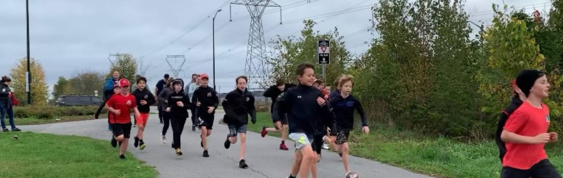 A smiling group of youth hockey players from the Ottawa Valley Silver Sevens U12 team running outdoors to raise funds for 2021 RBC Race for the Kids and CHEO