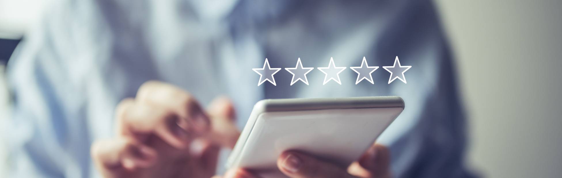 A young business owner on his phone adding a 5-star review on a virtual marketplace