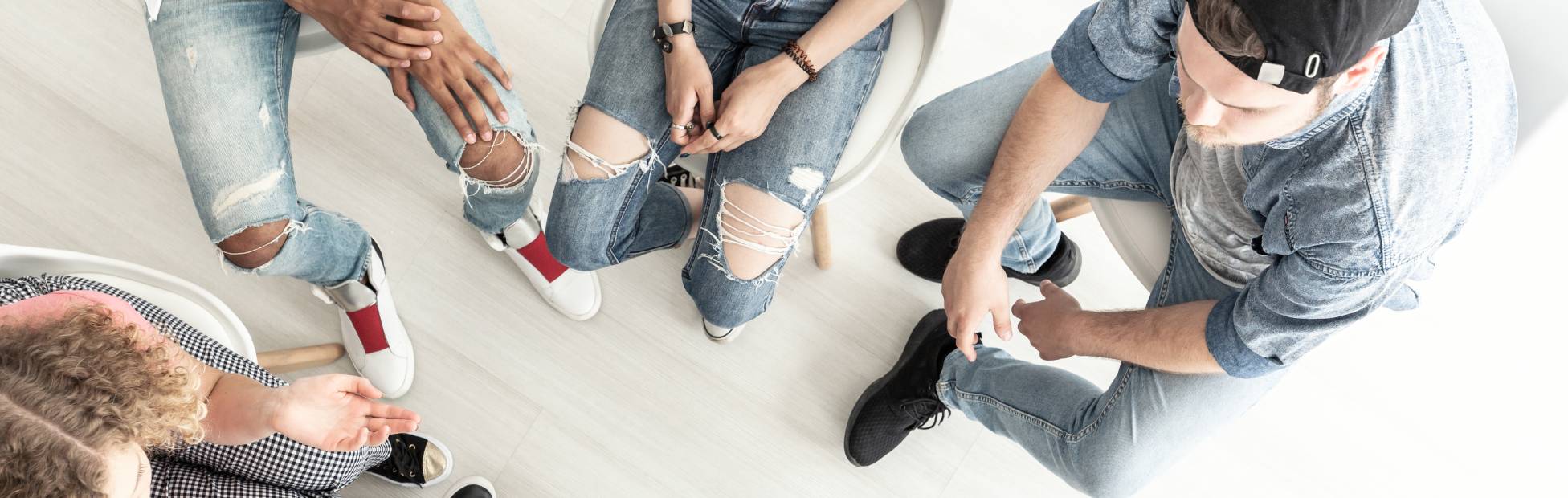 Overhead view of a psychotherapist working with a group of difficult teenagers in an anger management class