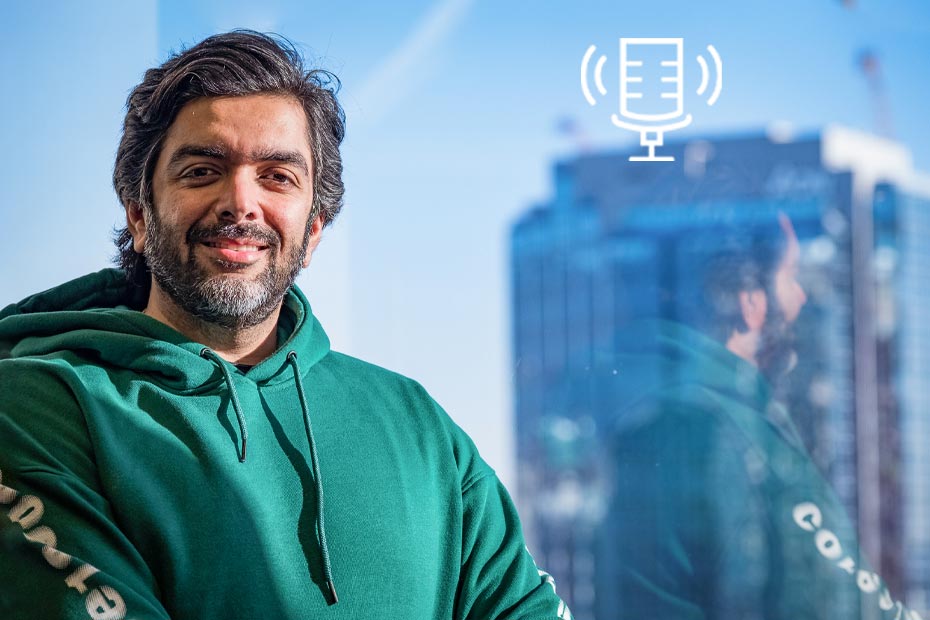 Internet influencer and entrepreneur Avi Arya wearing a green hoodie beside a window in a high-rise building on Tony Chapman's Chatter That Matters.