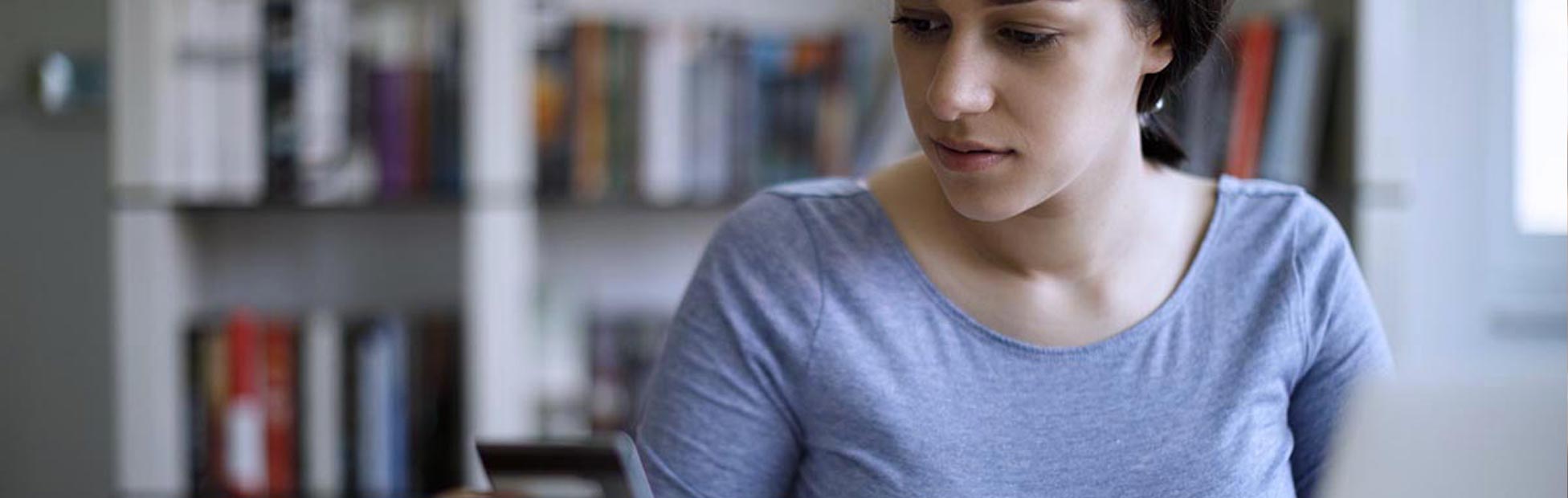 Image showing a young woman paying bills with a credit card
