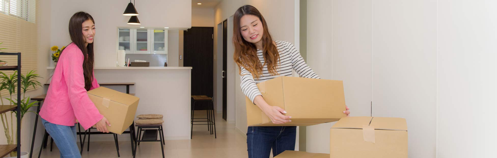 A young couple unpacking boxes and cleaning during their move in day for their new home.