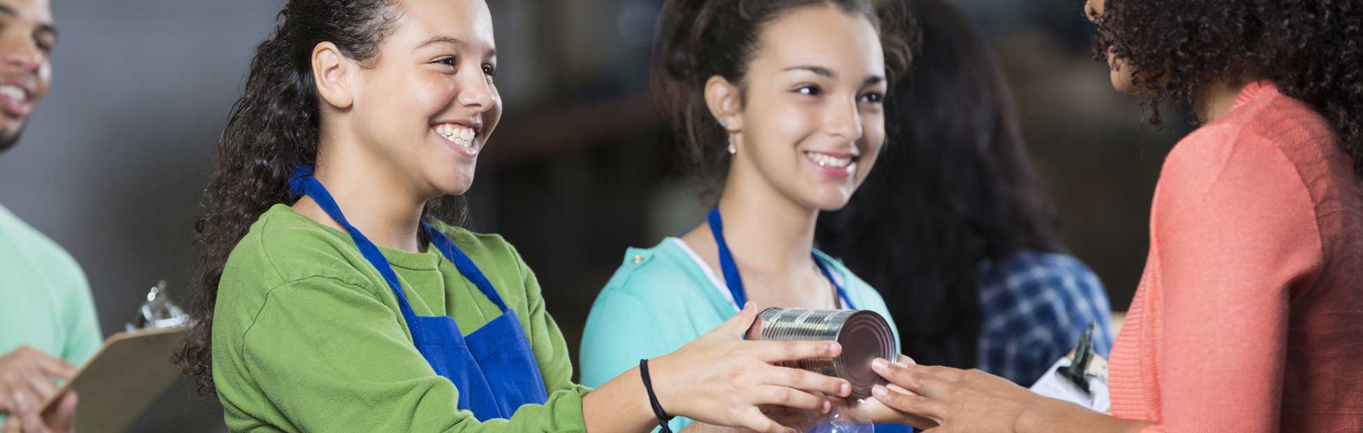 Two young volunteers helping with a holiday food drive