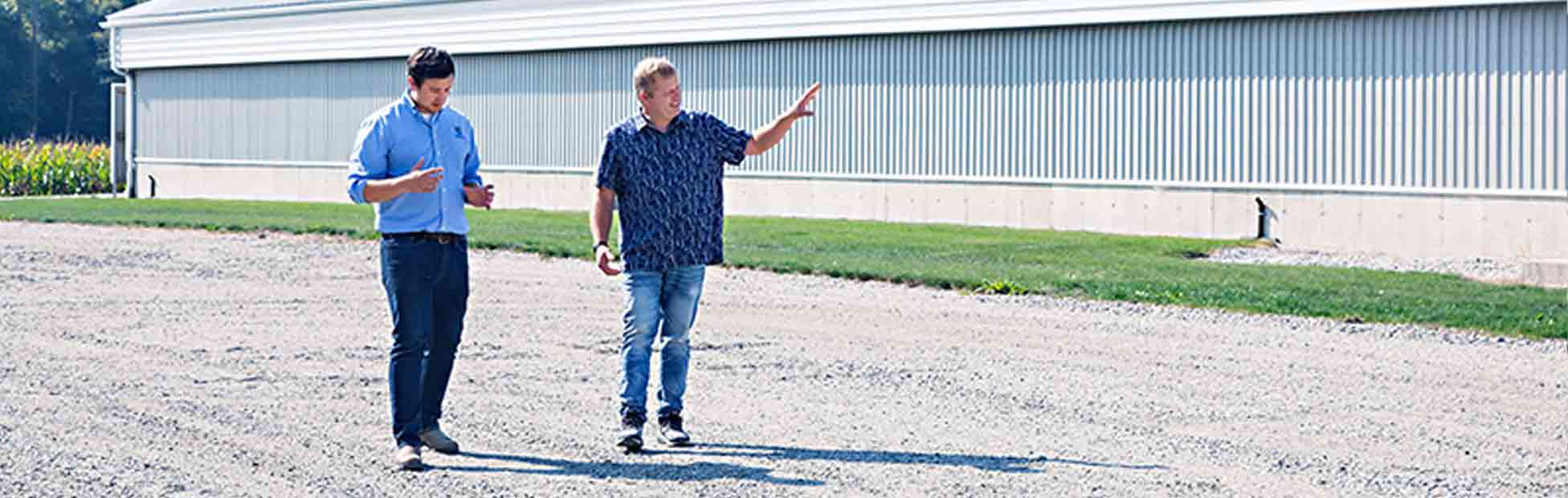 Farmers are standing in a field discussing opportunities