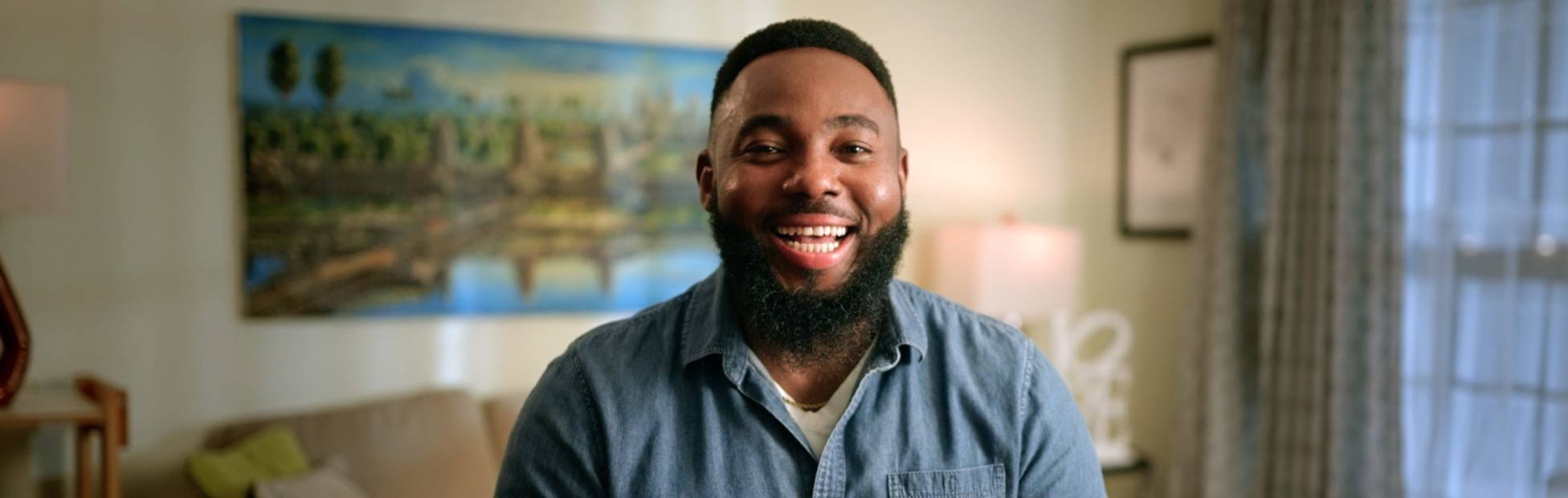 Entrepreneur and community advocate Chijioke Amadi sitting indoors smiling