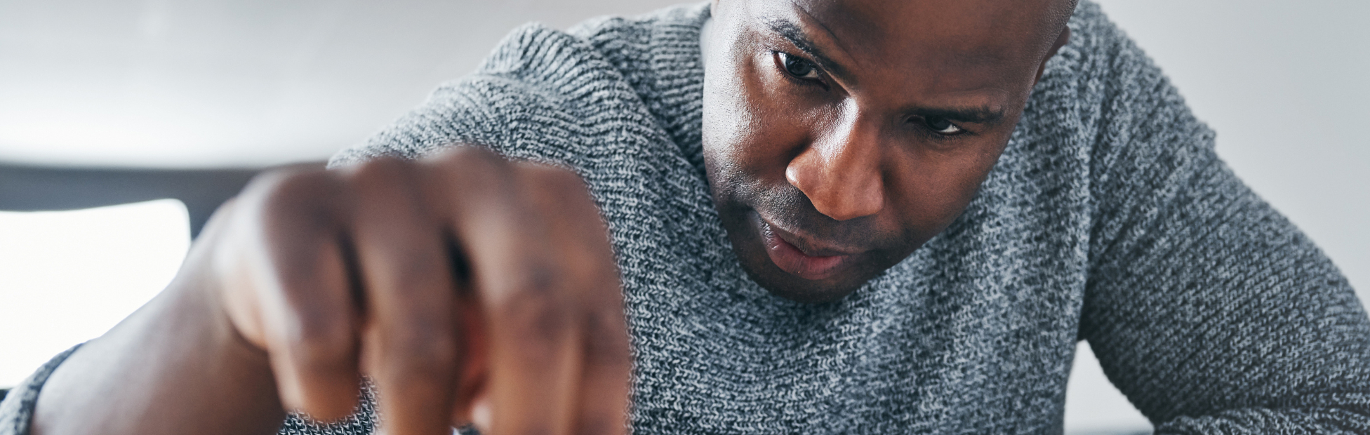 A close-up of a male business owner strategically moving a chess piece