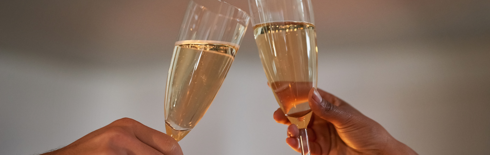 A couple's hands, toasting with champagne