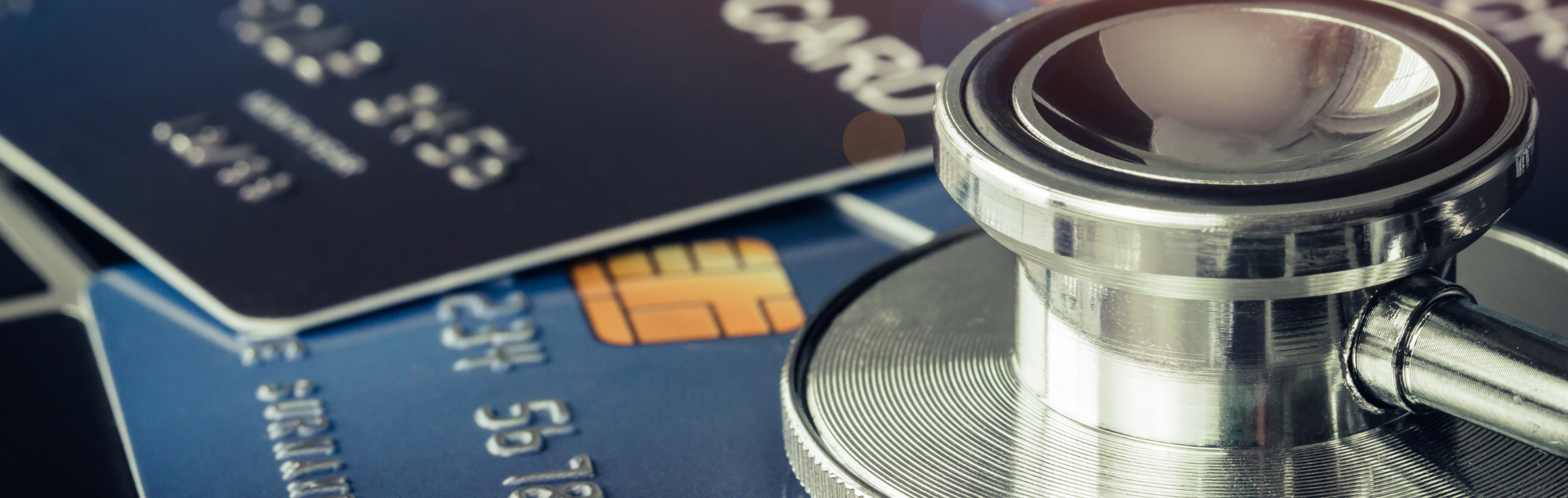 A pair of credit cards with a doctor's stethoscope
