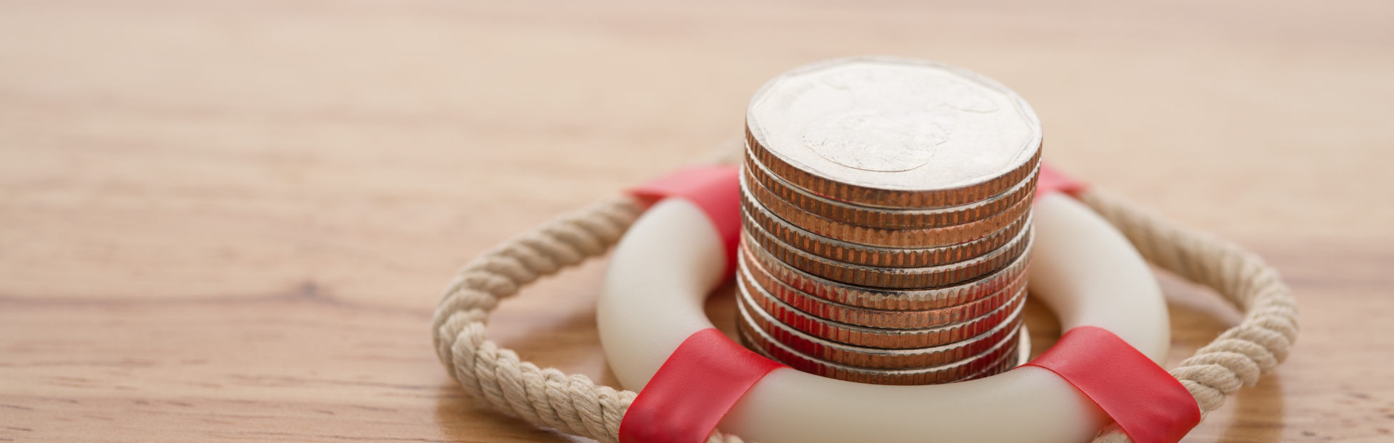 Miniature life saving ring with coins stacked inside