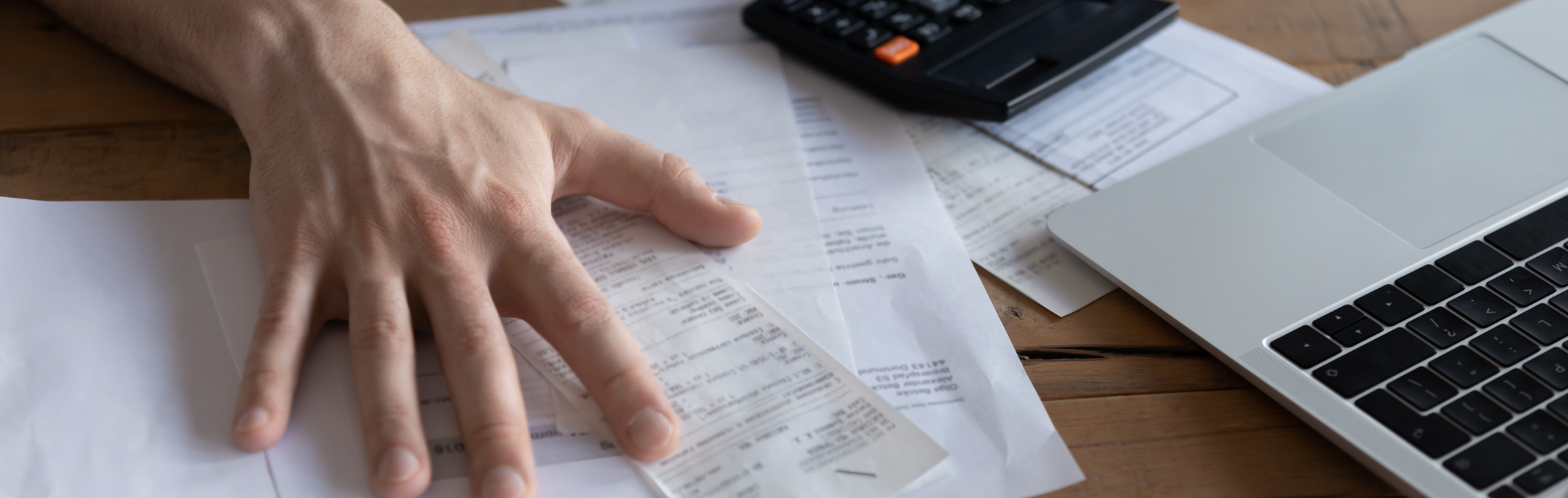 Entrepreneur struggling with bills and a calculator