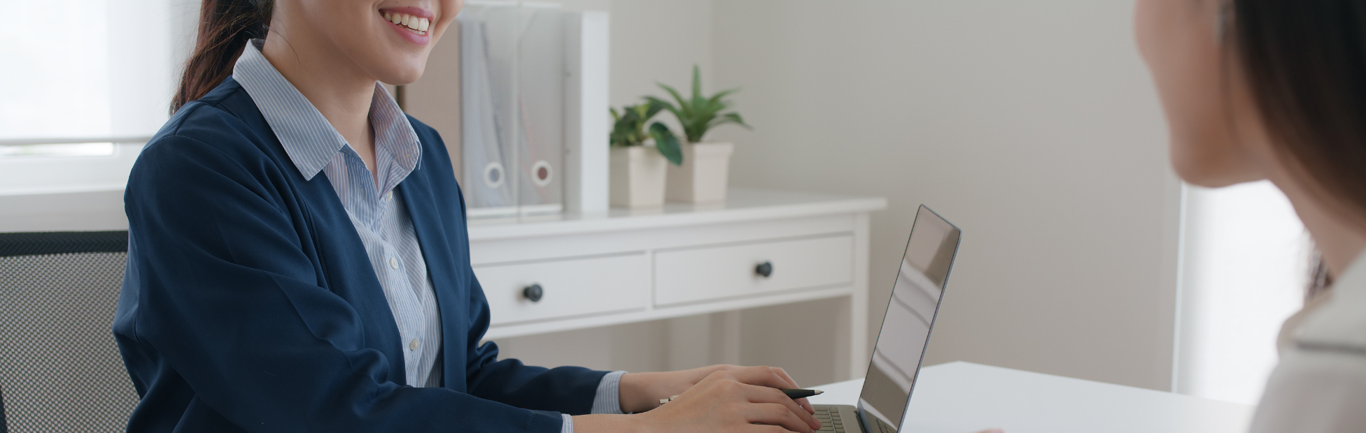 Female Asian banker speaking with a female client