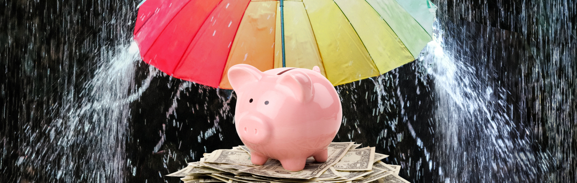 Pink piggy bank shielded from the rains by a colourful umbrella